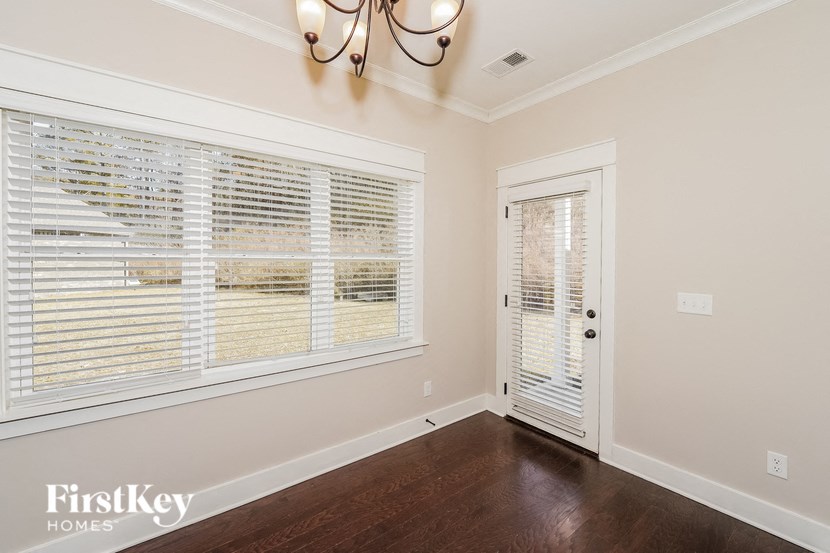 a living room with a large window and a door to a closet