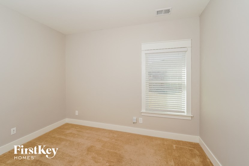 a room with a carpet and a window