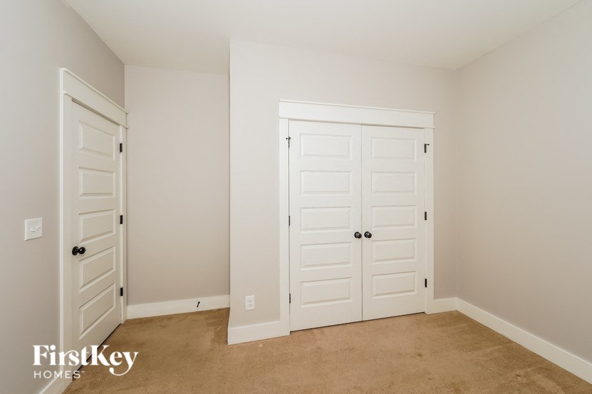 a bedroom with two closets and two doors