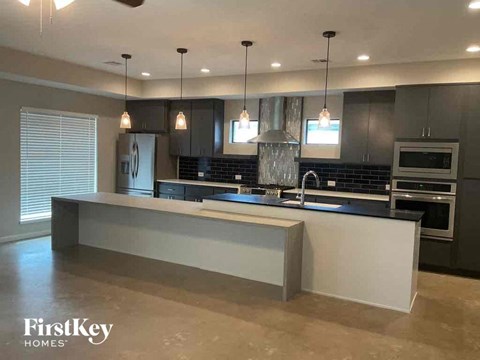 A modern kitchen with a large island in the center.