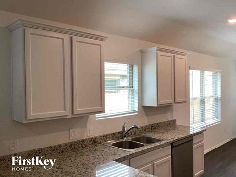 a kitchen with white cabinets and a sink