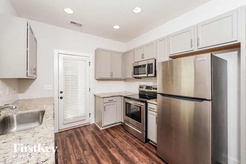 a kitchen with stainless steel appliances and white cabinets