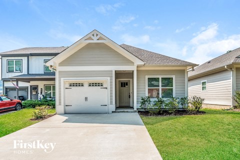 a white house with a driveway and a garage door