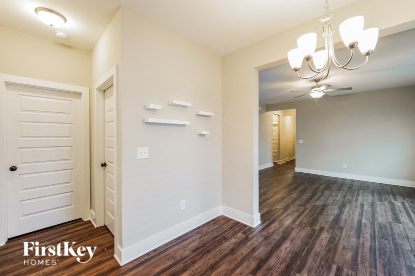 a living room with wood flooring and a white door