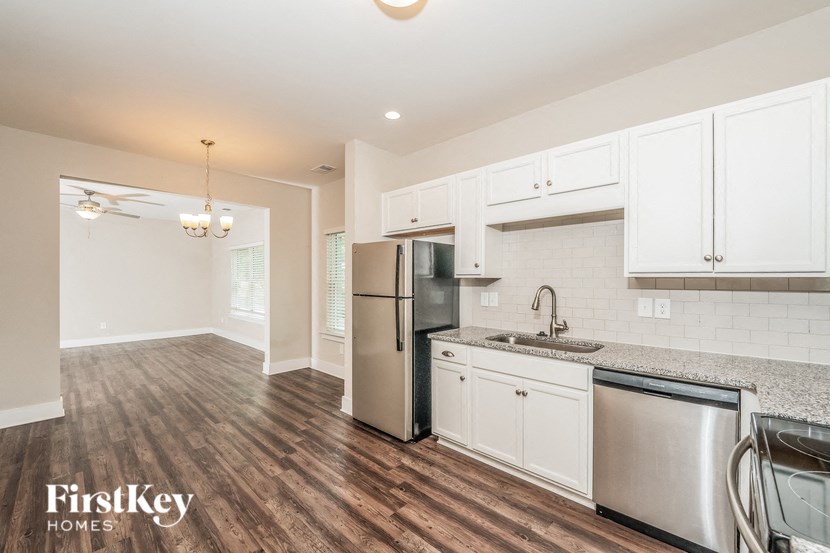 a kitchen with stainless steel appliances and white cabinets