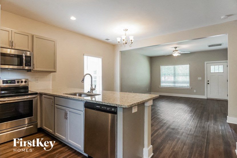 an empty kitchen with a counter top and a sink