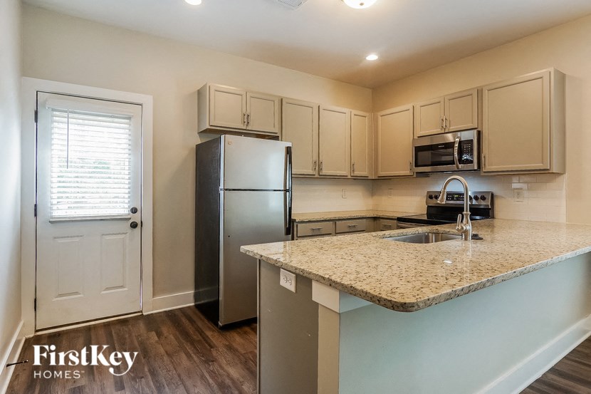 a kitchen with a granite counter top and a refrigerator