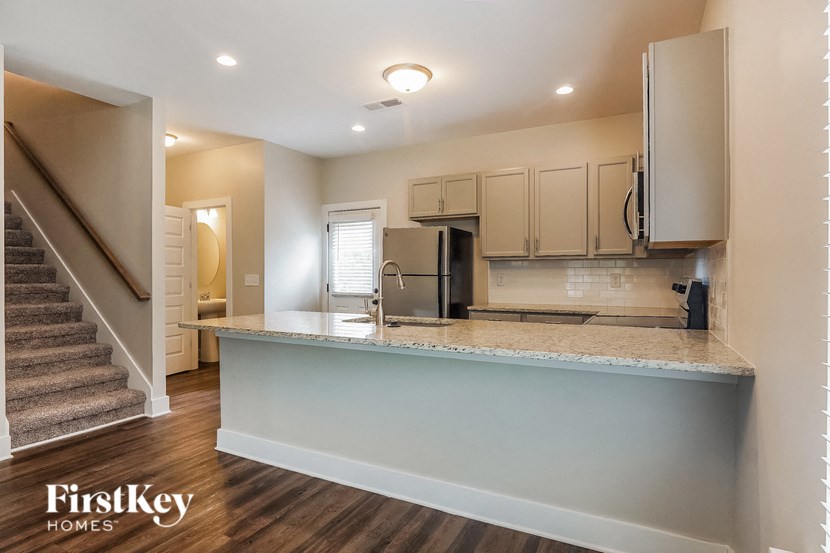 a kitchen with a counter top and a staircase