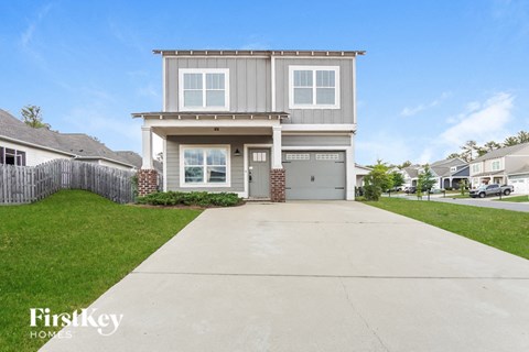 a gray and with a driveway in front of it
