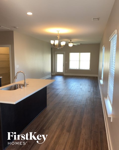 A kitchen with a sink and a FirstKey Homes logo.