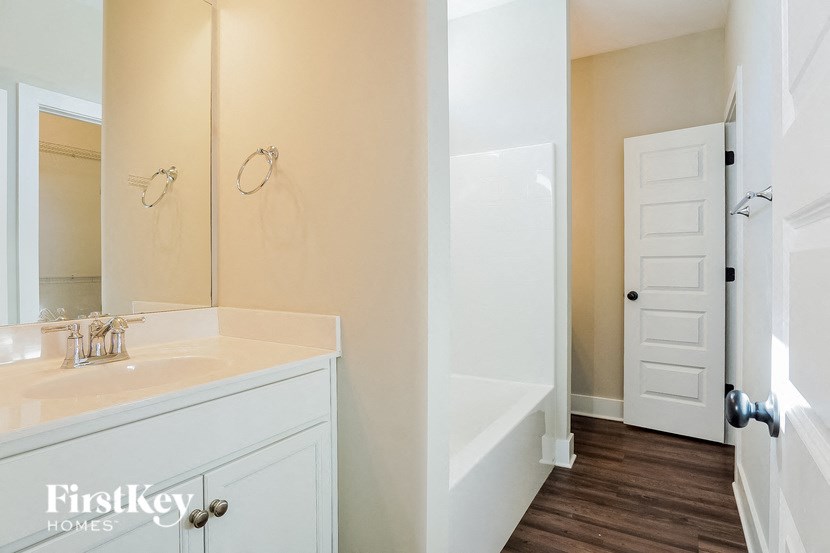 a bathroom with a sink and a tub and a mirror