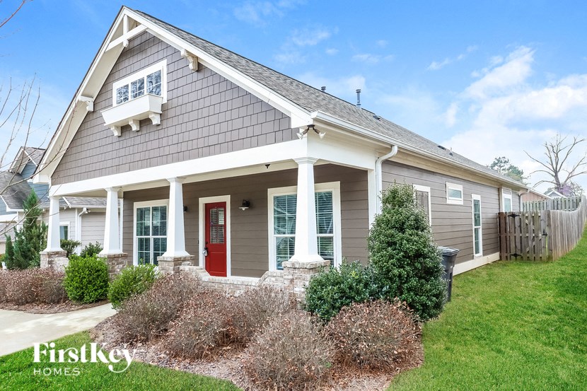a craftsman style home with a red front door