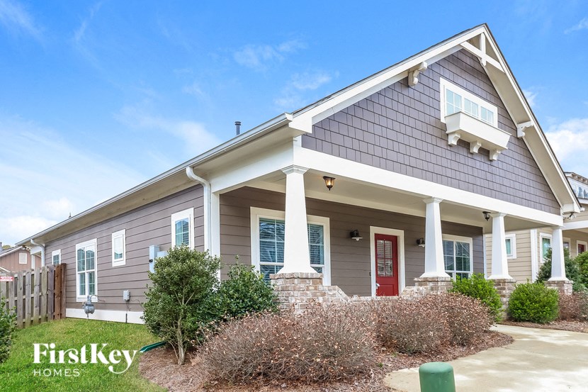 a home with a porch and a red door