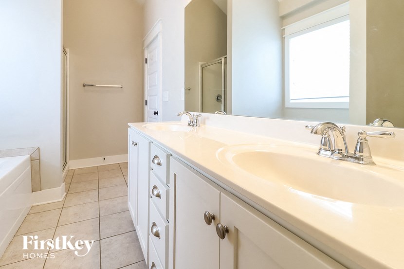 a bathroom with a white sink and a mirror