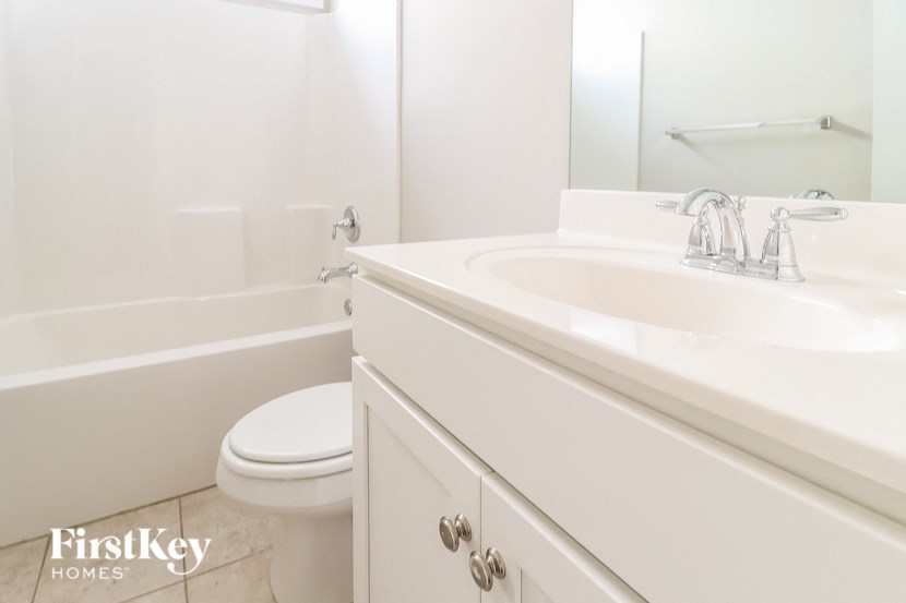 a white bathroom with a sink and a toilet