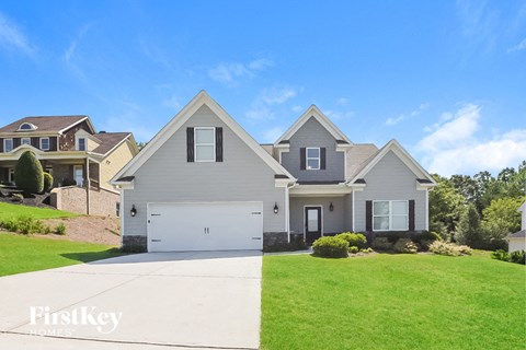 a house with a green lawn and a white driveway