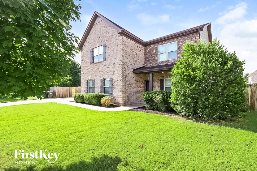 a brick house with a lawn in front of it