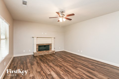 the living room has a fireplace and hardwood floors