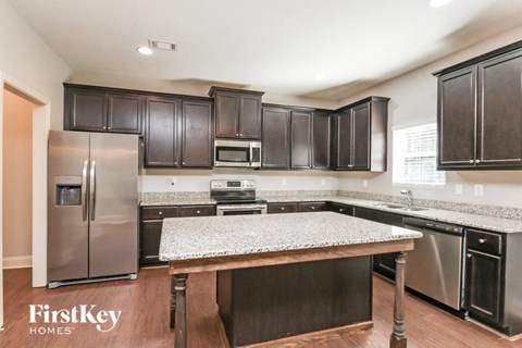 a kitchen with stainless steel appliances and granite counter tops