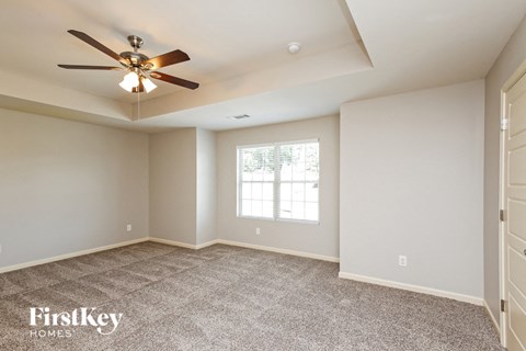 the master bedroom is spacious and has a ceiling fan