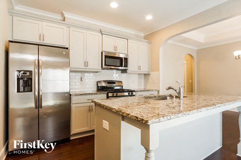 a kitchen with stainless steel appliances and a granite counter top