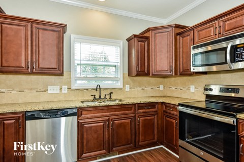A kitchen with brown cabinets and a stainless steel dishwasher.