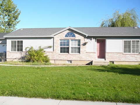 A house with a red door and a grey roof.
