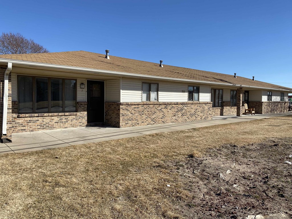 a white house with a sidewalk in front of it