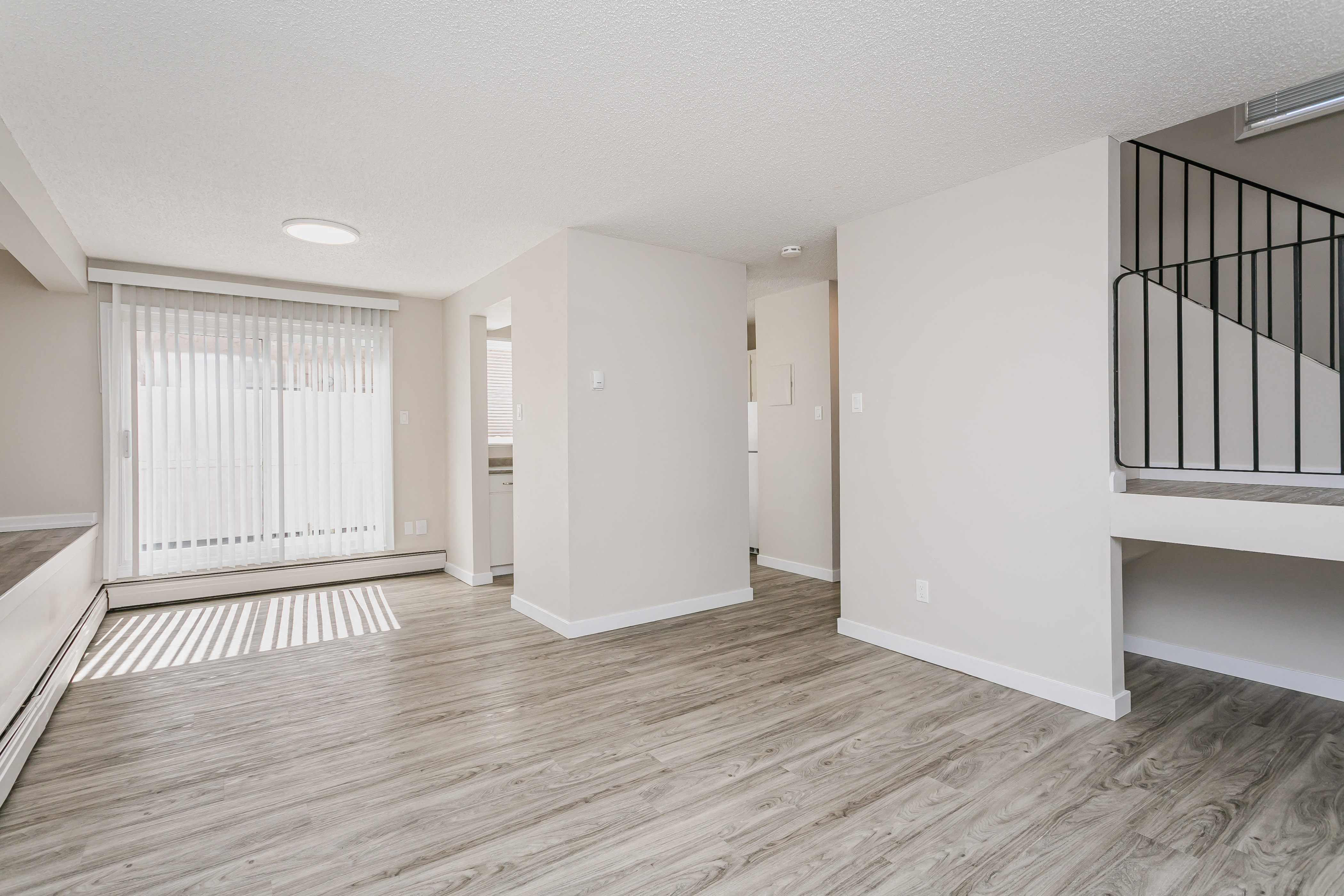 the spacious living room and dining room of an apartment