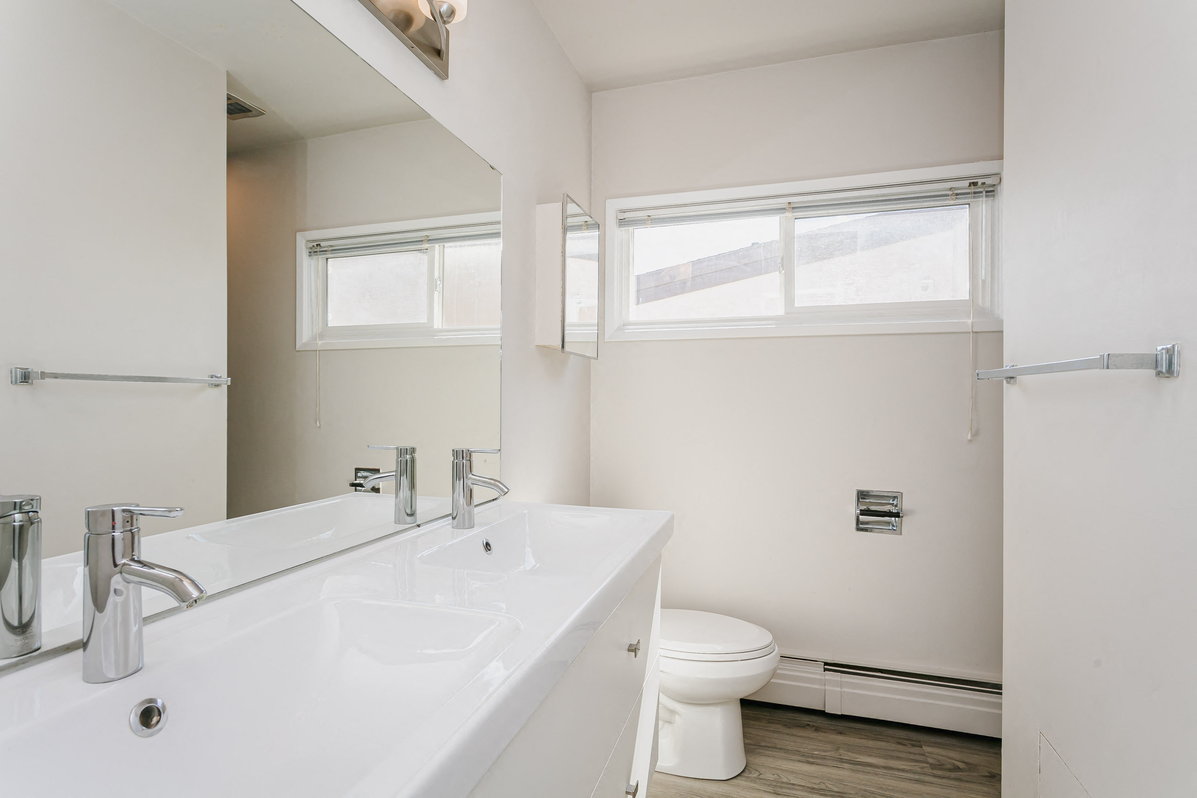 a bathroom with a sink and a toilet and a mirror