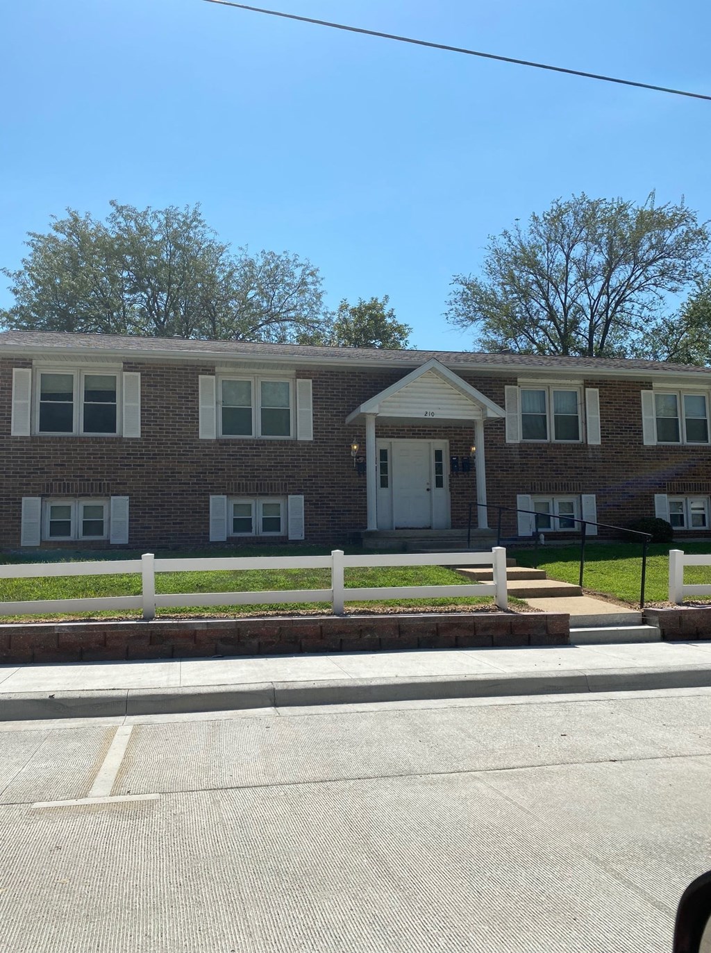 a large brick building with a street in front of it