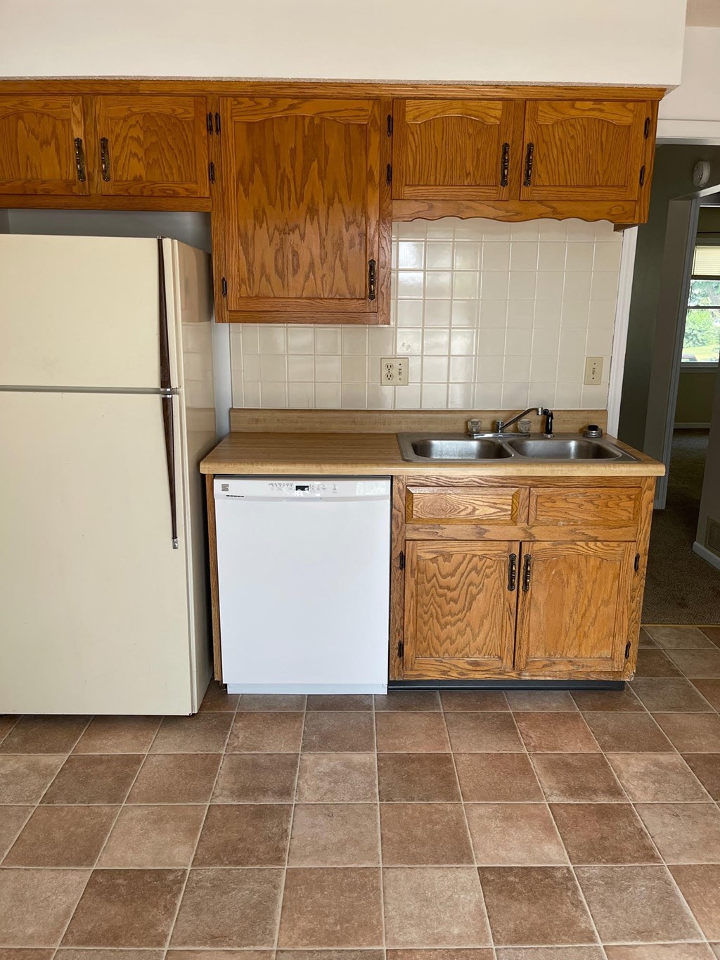 a kitchen with a sink and a refrigerator