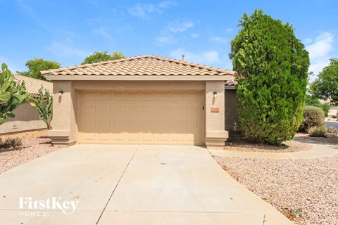a home with a garage door and a driveway