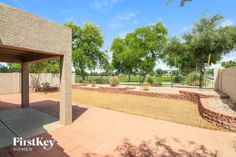 a view of the backyard of a house with a garden and trees
