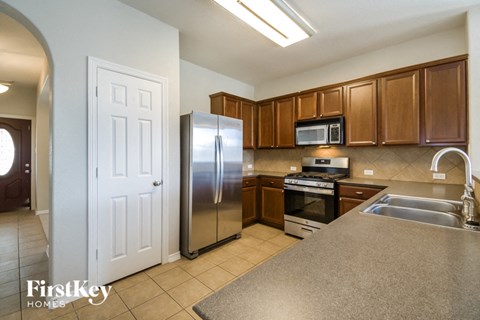 a kitchen with stainless steel appliances and wooden cabinets