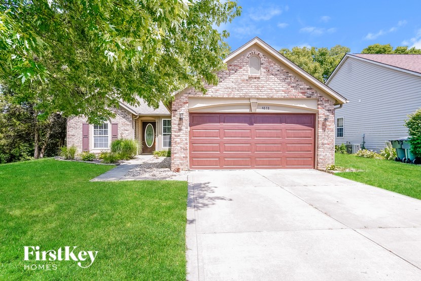 A house with a red garage door is for sale.