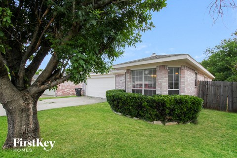 A house with a tree in front of it.