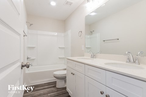 a white bathroom with a sink and a toilet