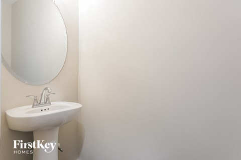 a white bathroom with a sink and a mirror