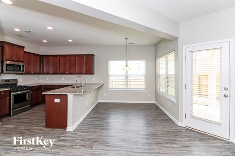 A kitchen with brown cabinets and a white island.