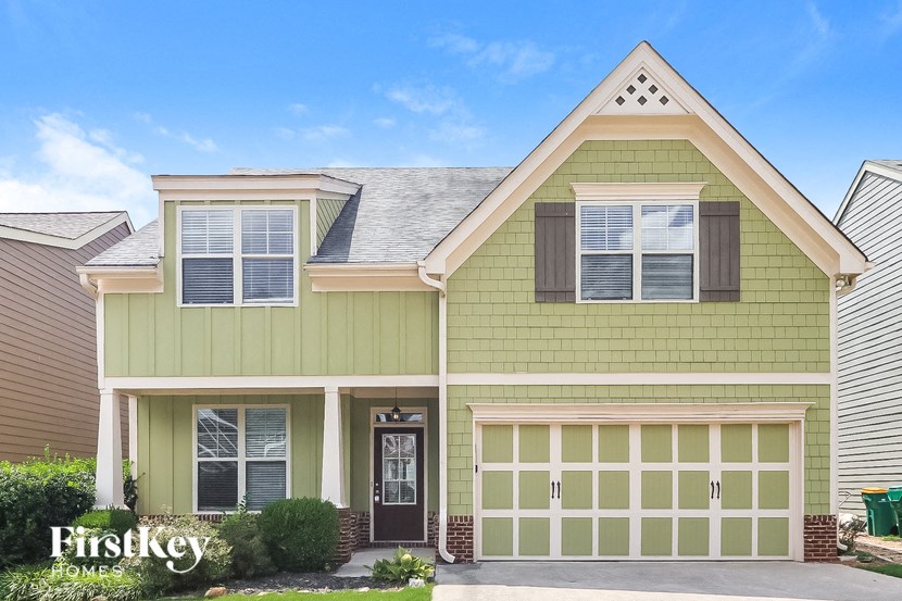 the front exterior of a house with a garage door