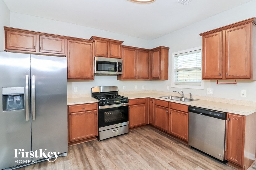 a kitchen with wooden cabinets and stainless steel appliances