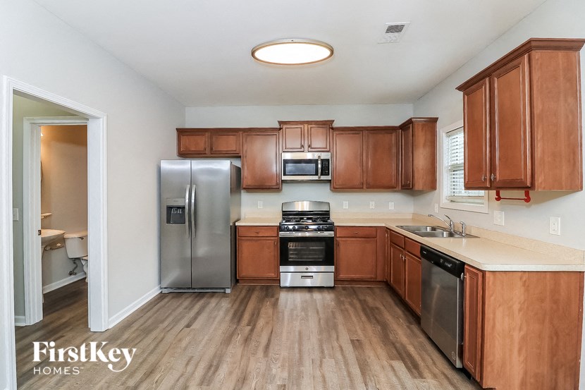 a kitchen with wooden cabinets and stainless steel appliances