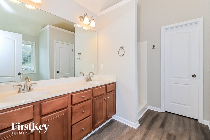 a bathroom with two sinks and a large mirror