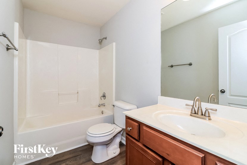 a bathroom with a sink toilet and a bath tub