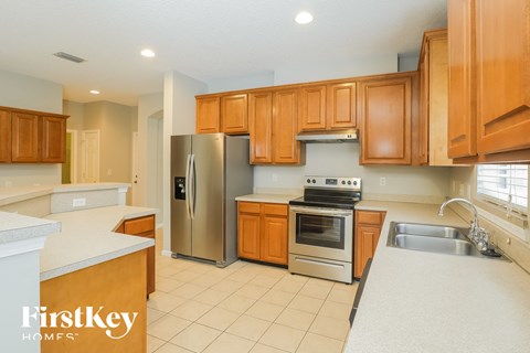 a kitchen with wooden cabinets and stainless steel appliances