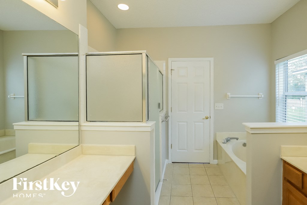 a bathroom with a shower and a sink and a tub