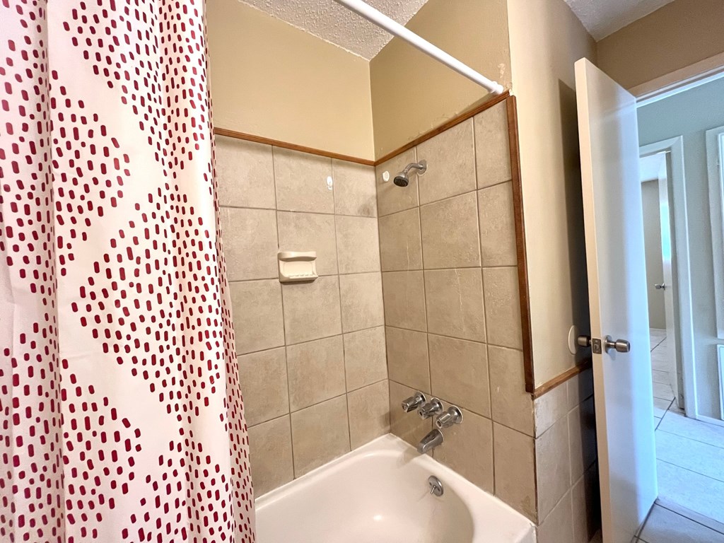 a bathroom with a shower curtain and a sink
