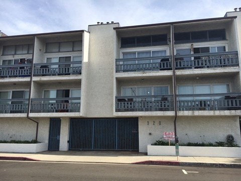 A multi-story building with a balcony on each floor.
