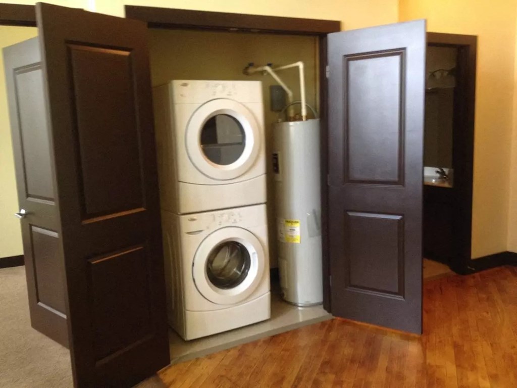 a washing machine and dryer in a room with doors